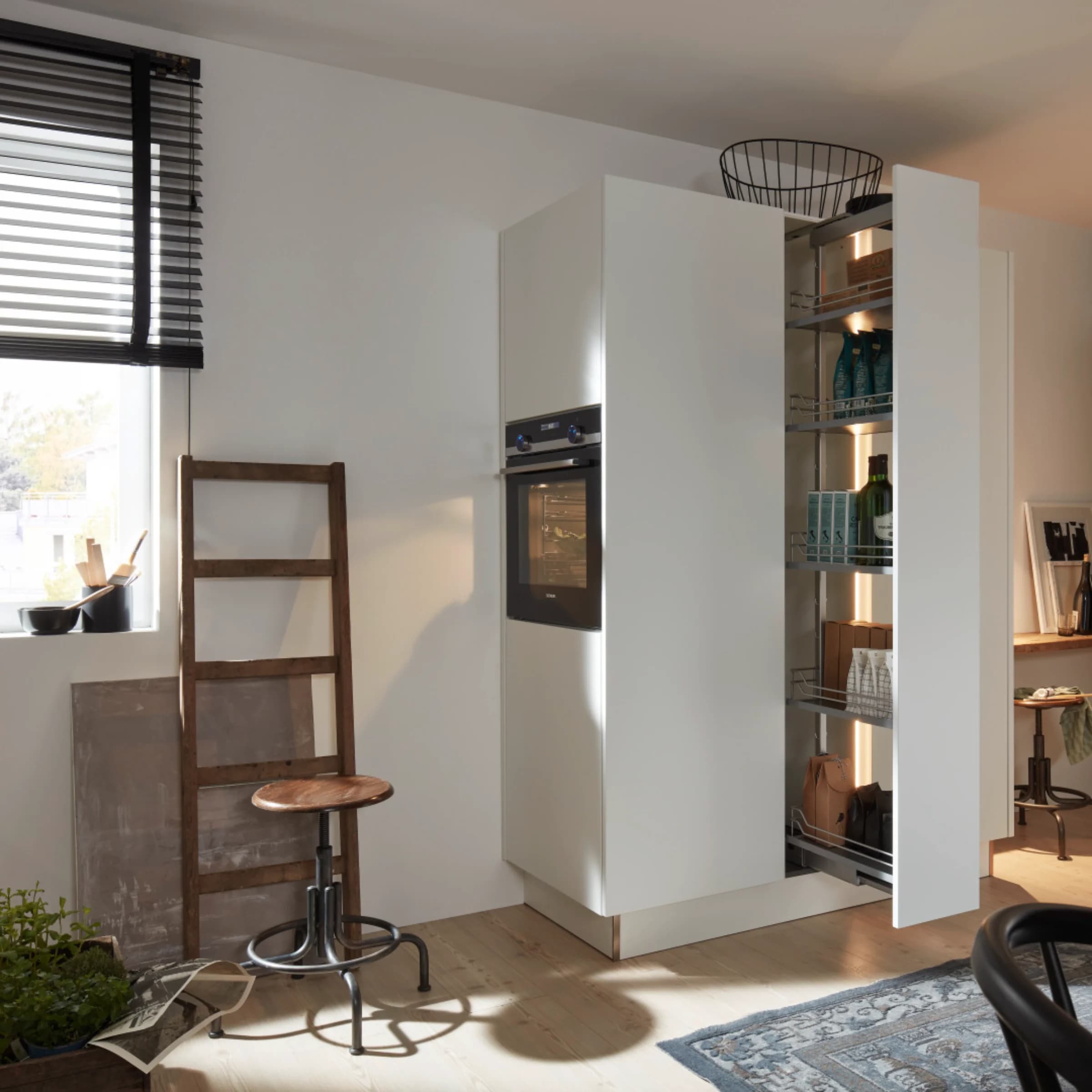 A modern utility room with shelving and oven, equipped by Nolte Utility Rooms.