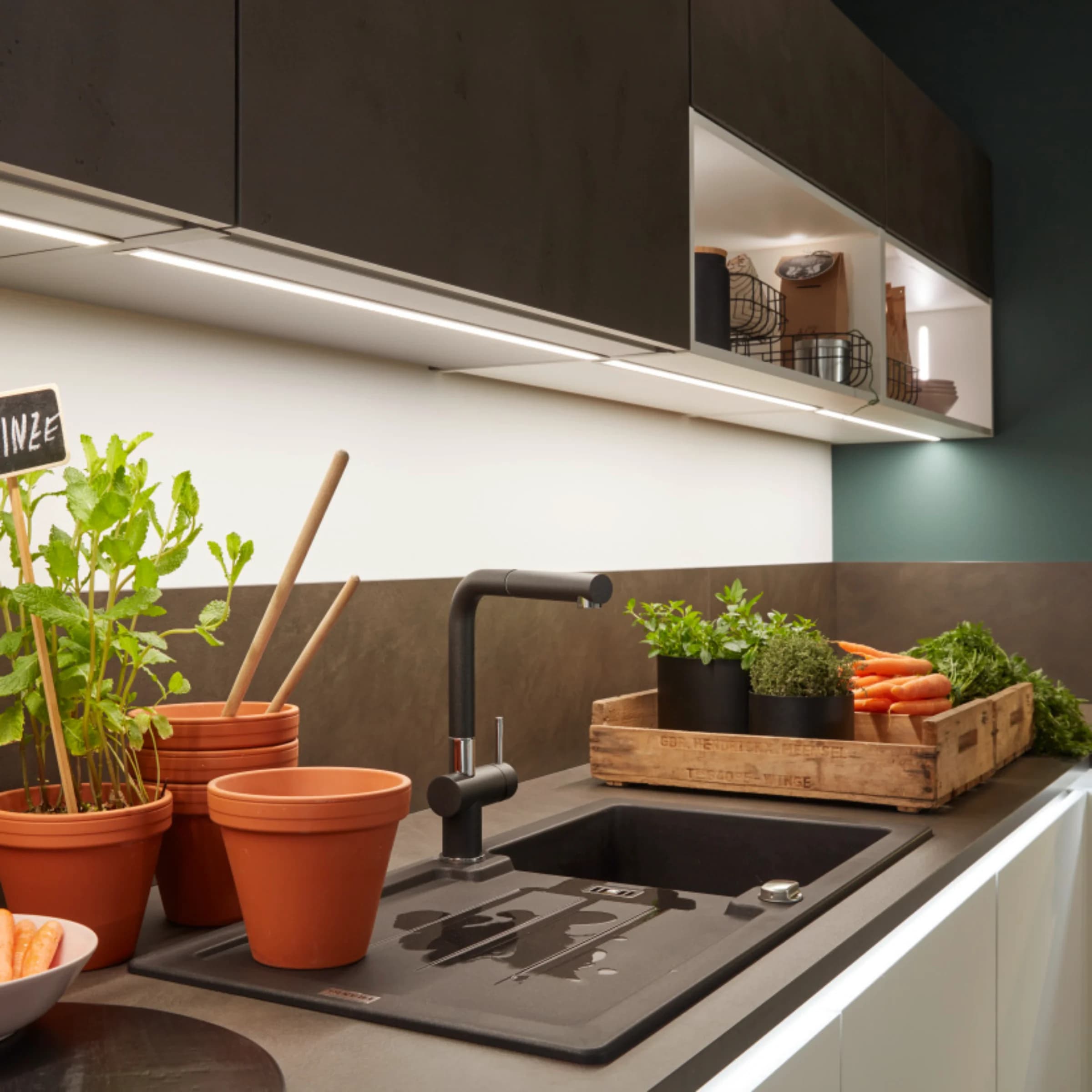 A modern kitchen with plants and vegetables on the countertop, Nolte Kitchen.